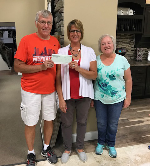 $300 check presented to Rob and Barb Carpenter for Marathon Benefit III